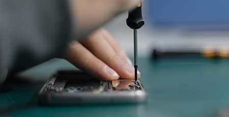 Phone repairing with a screw driver.